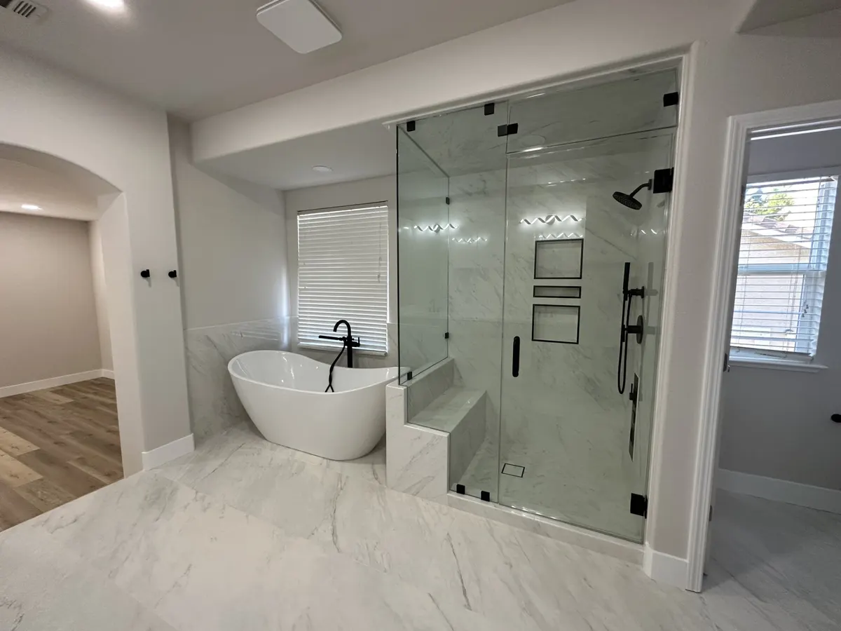 Primary bathroom with a freestanding tub and a frameless glass walk-in shower